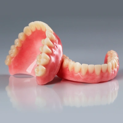 Complete dentures replacing a full arch of missing teeth
