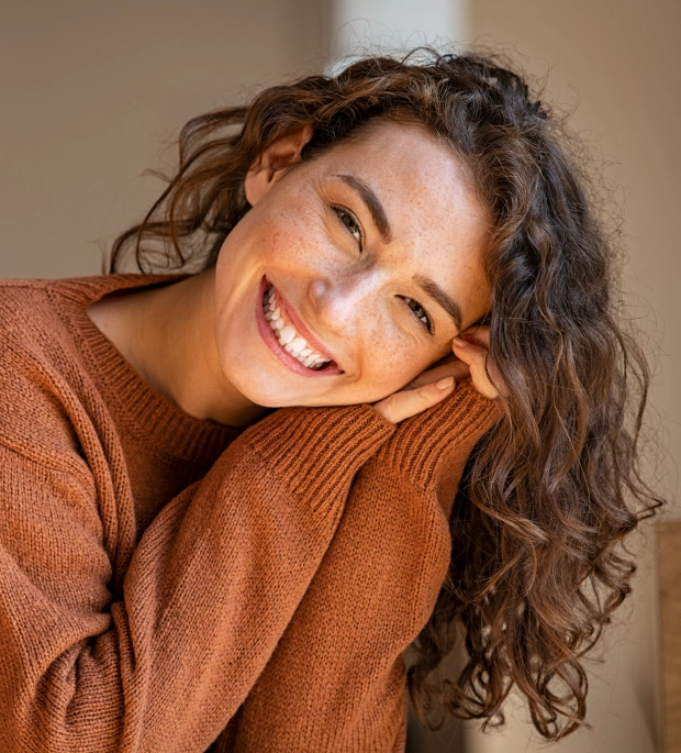 Woman smiling after cosmetic dentistry treatment
