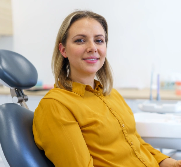 Patient smiling during a routine dental cleaning and exam