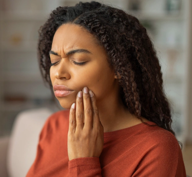 Patient experiencing a dental emergency with tooth pain