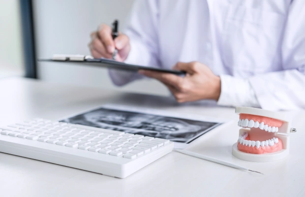 Patient reviewing dental insurance and financing paperwork